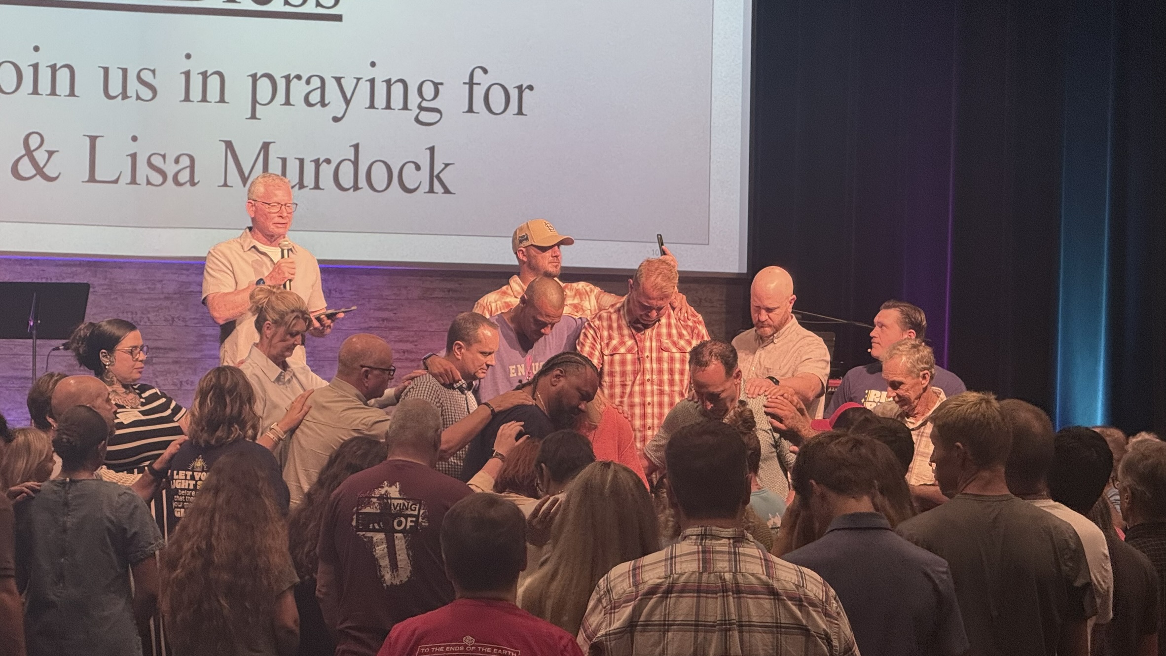 Church family gathering in prayer